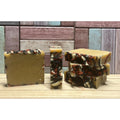 Three bars of Apple Cider soap with a marbled pattern on a wooden surface, with a wooden paneled background.