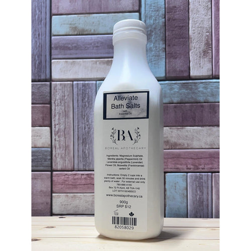 Bottle of 'Alleviate Bath Salts' with a wooden background
