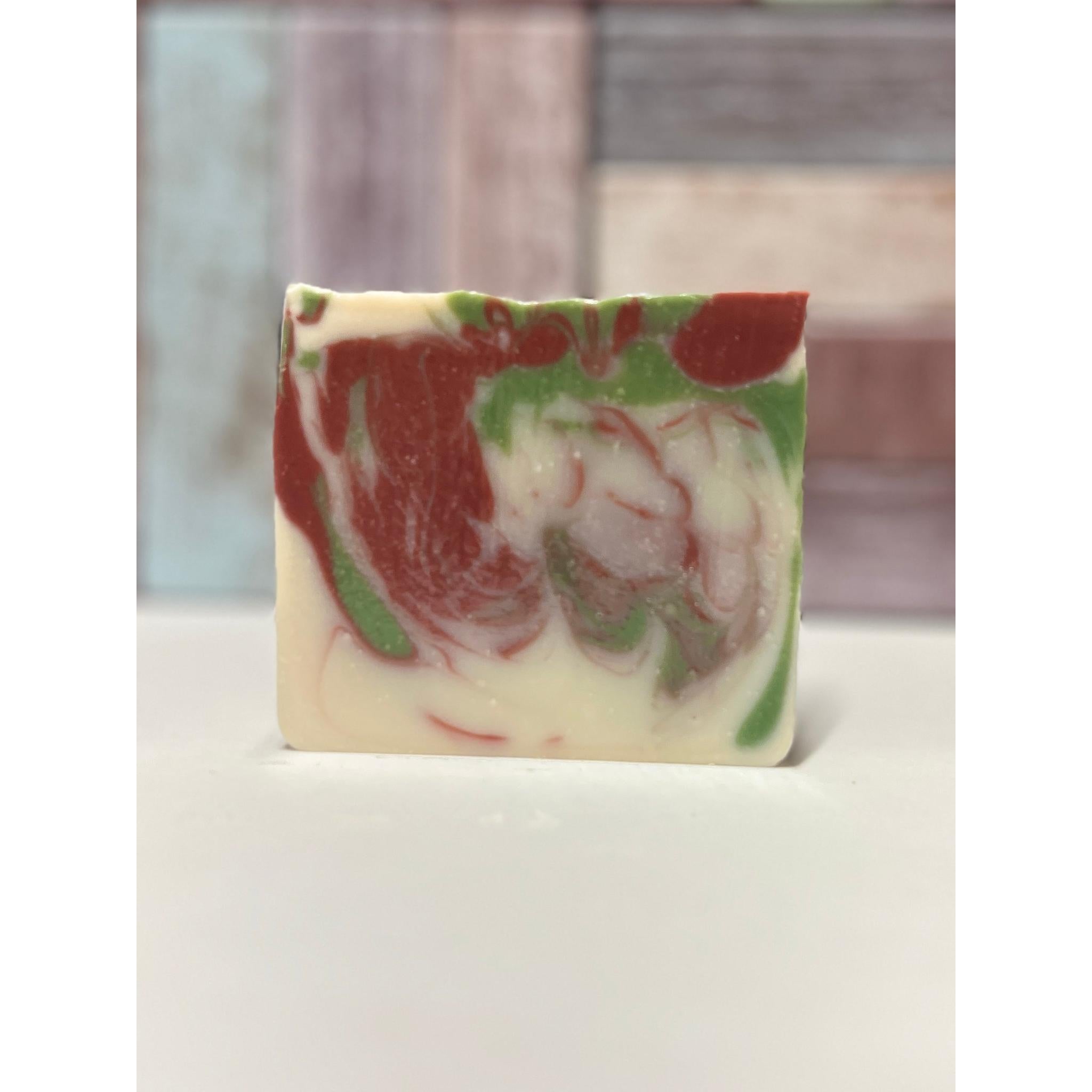Marbled Candy Cane soap bar with red, green, and white colours on a neutral background