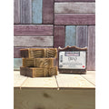 Three bars of Dragons Blood Bar Soap with a label on a wooden surface against a wooden background