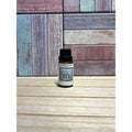 Small bottle with a label on a wooden surface and multicolored wooden panel background