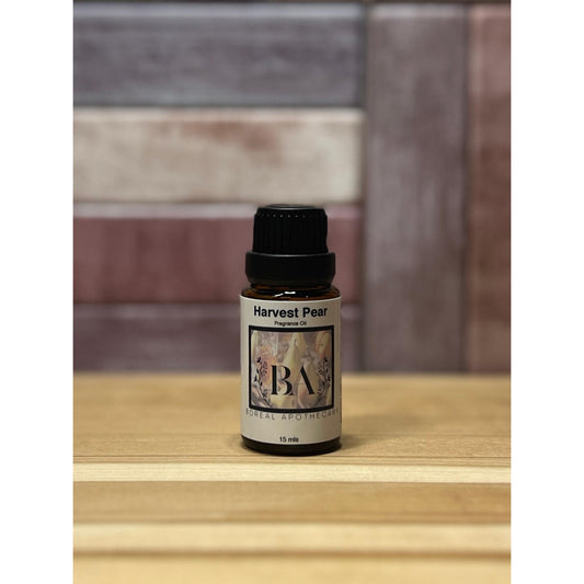 Bottle of Harvest Pear Fragrance Oil on a wooden surface with a tiled wall background