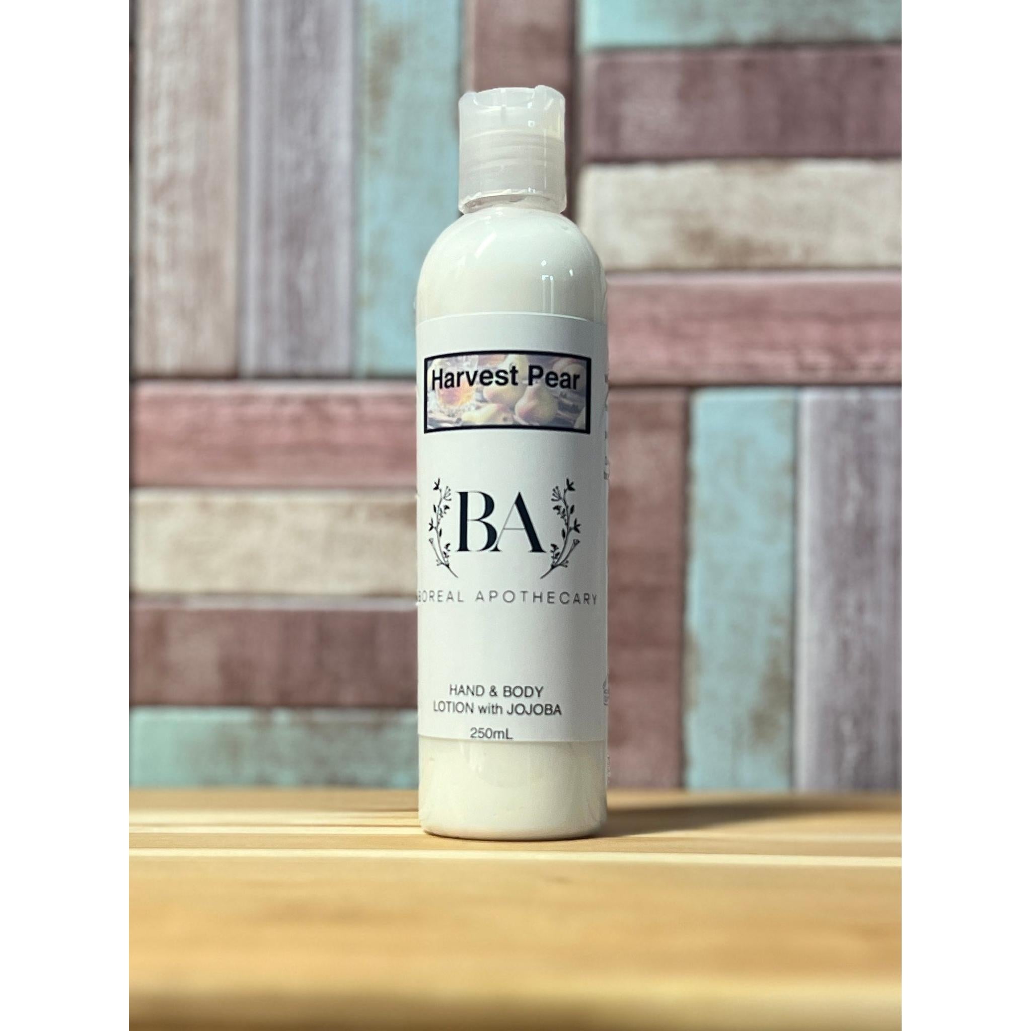 Harvest Pear lotion bottle on a wooden surface with a tiled wall background