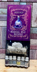 Set of bottles labeled 'BA' with a purple book titled 'Magical Oils Recipes' on a wooden surface.