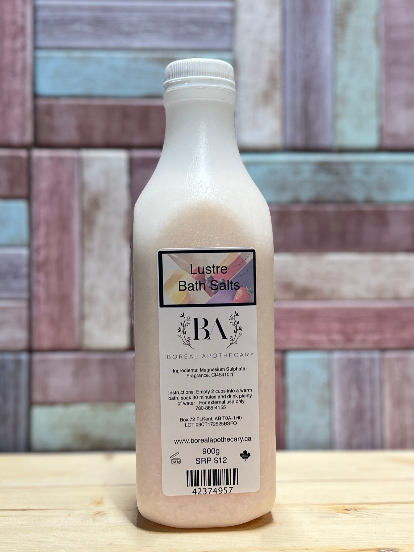 Bottle of Lustre Bath Salts on a wooden surface with a multicolored tile background