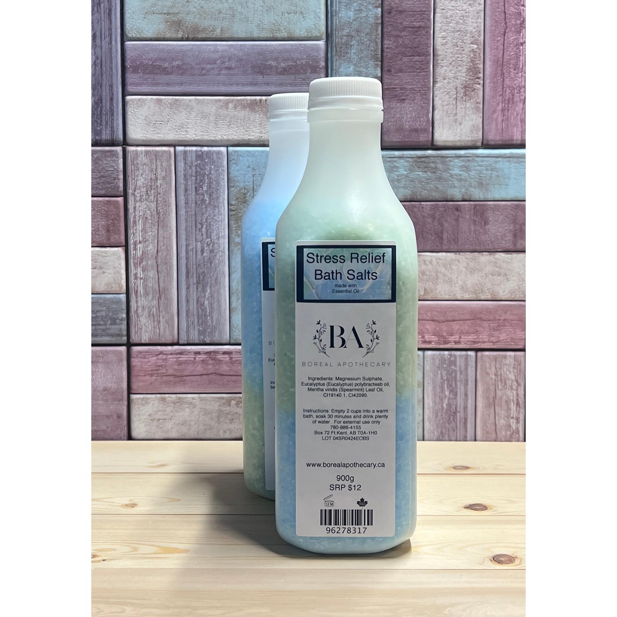 Bottle of 'Stress Relief Bath Salts' with 'BA' label on a wooden surface and tiled wall background