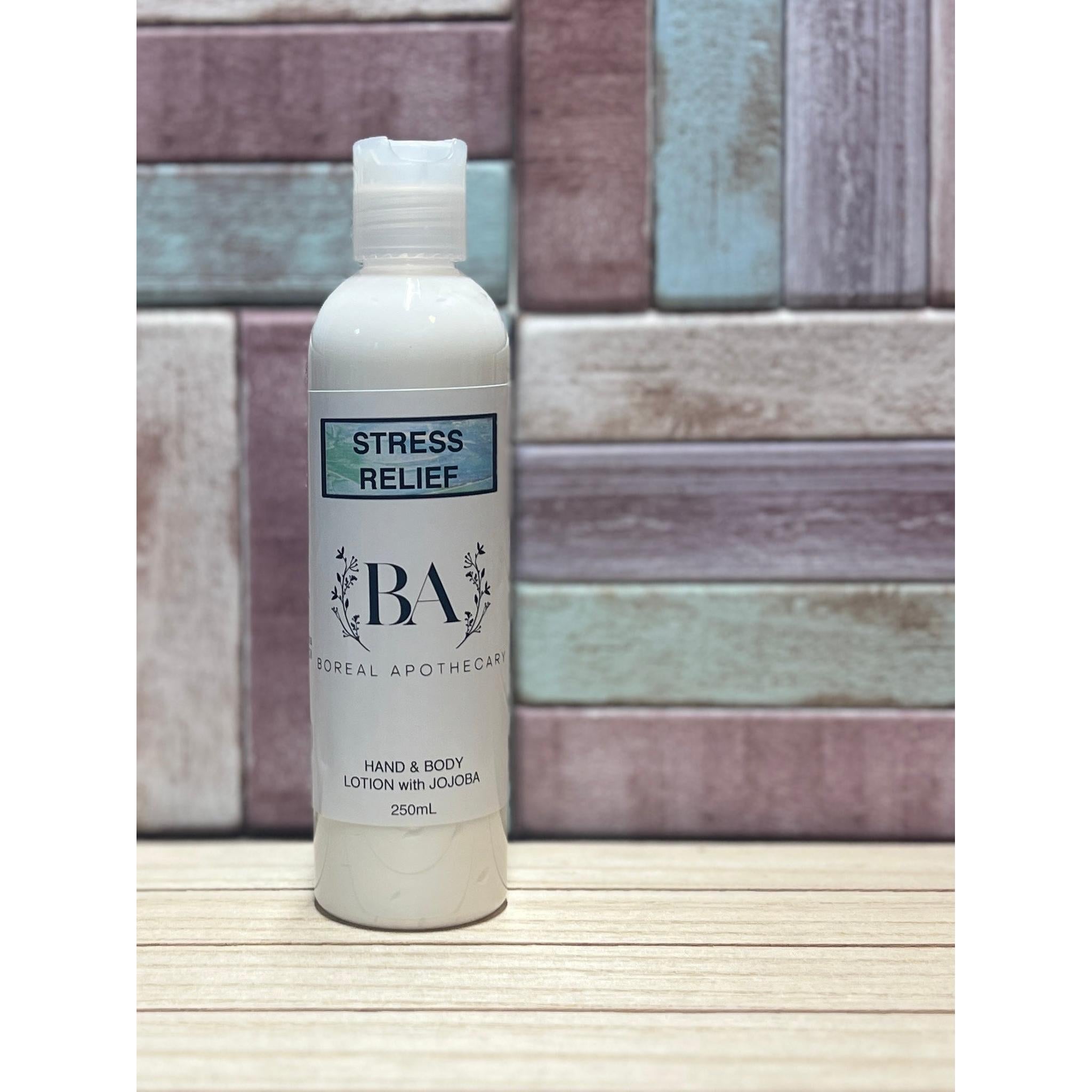 Bottle of 'Stress Relief' lotion by BA Lorient Apothecary on a wooden surface with a tiled wall background.