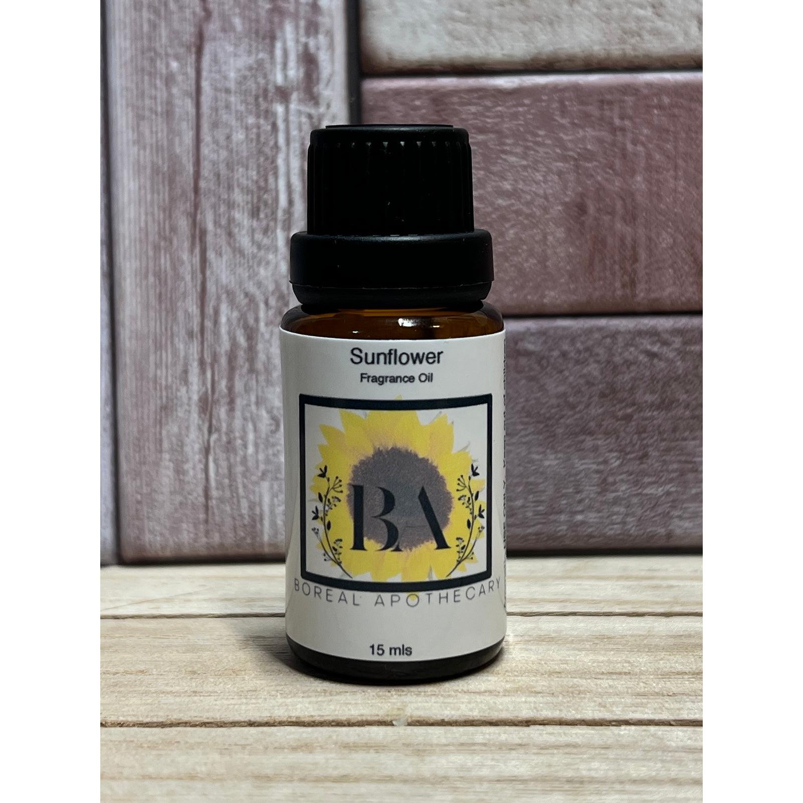 Bottle of Sunflower Fragrance Oil by Boreal Apothecary on a wooden surface with a wooden background.