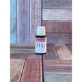 Bottle of Cedarwood essential oil on a wooden surface