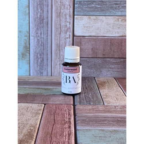 Bottle of Cedarwood essential oil on a wooden surface