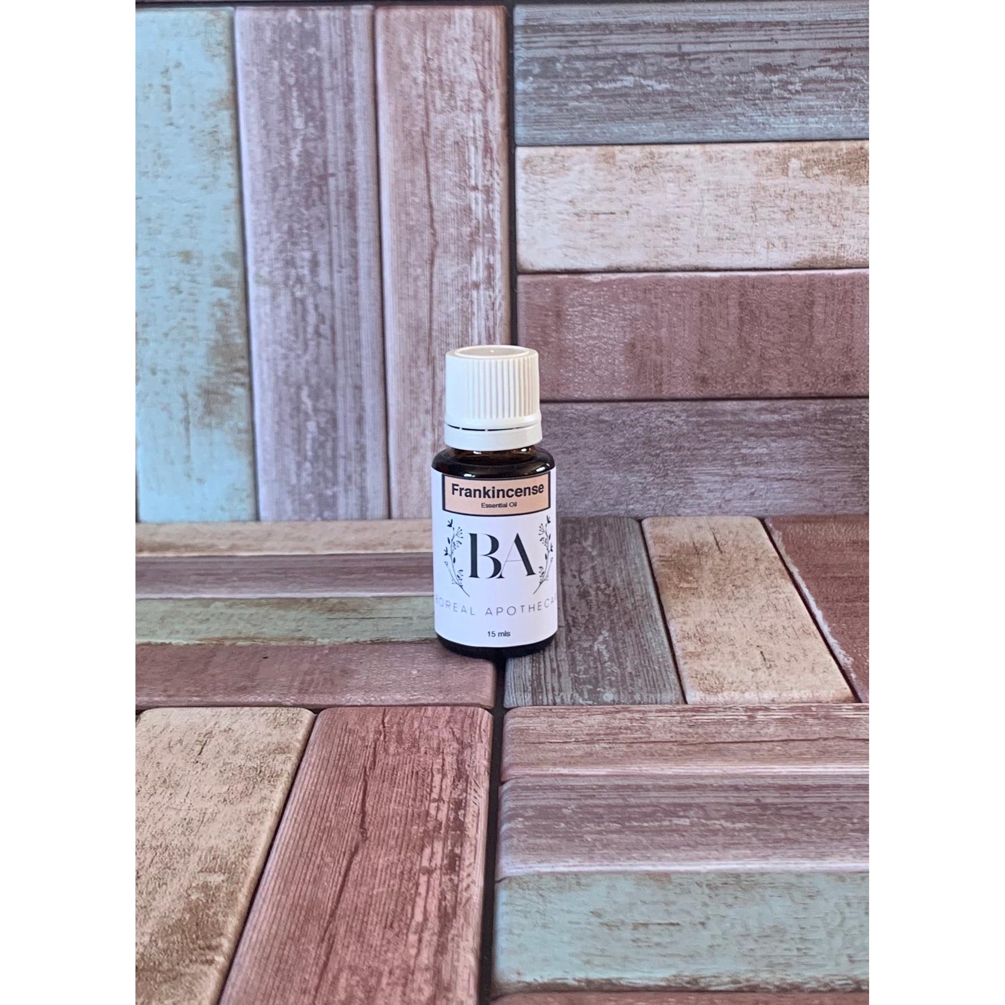 Bottle of Frankincense oil on a wooden surface