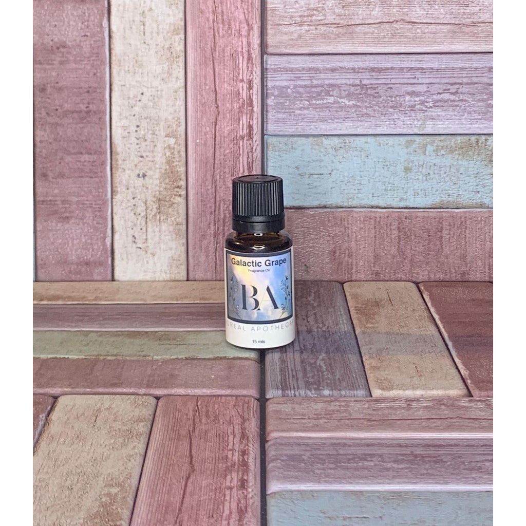 Bottle of 'Galactic Grape' Fragrance Oil on a wooden surface