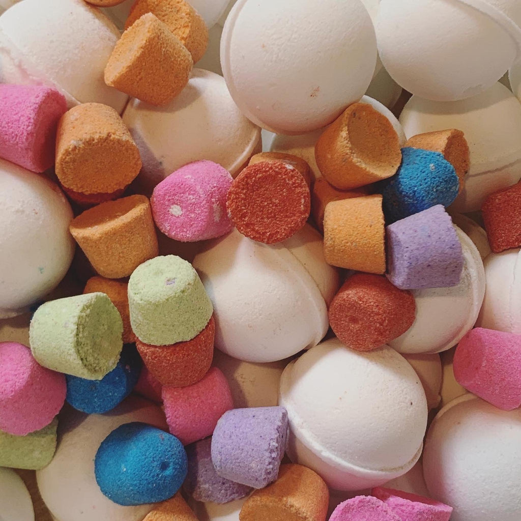 Colorful bath bombs in various shapes and sizes.