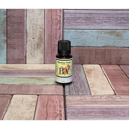 Bottle labeled 'Monkey Farts' on a wooden surface