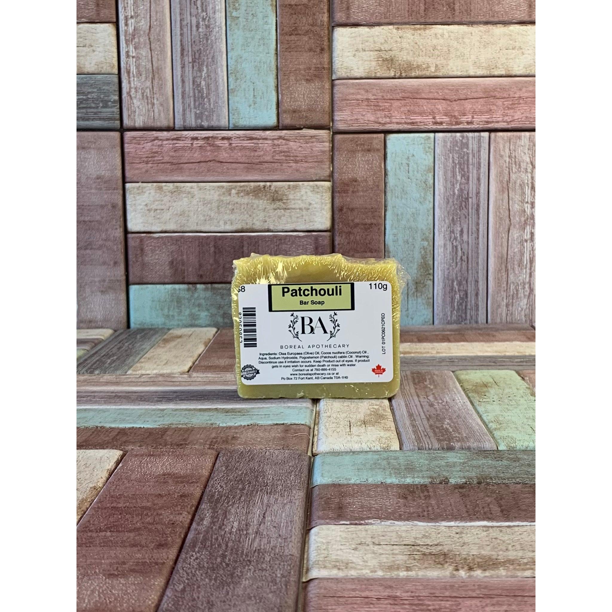 Packaged Patchouli  soap bar with 'Boreal Apothecary' branding on a wooden background