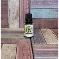 Bottle of pineapple Fragrance Oil on a wooden surface