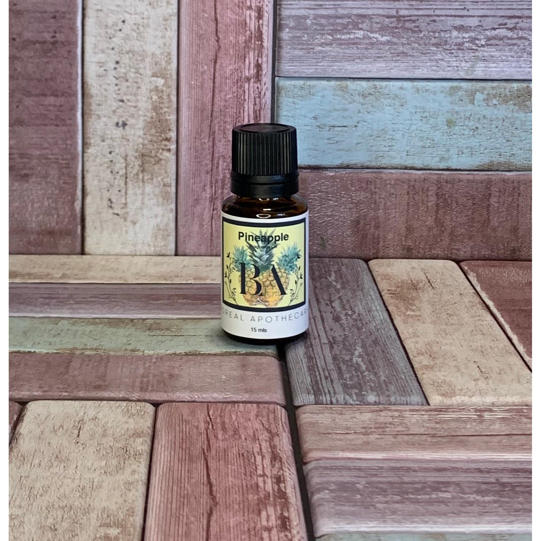 Bottle of pineapple Fragrance Oil on a wooden surface