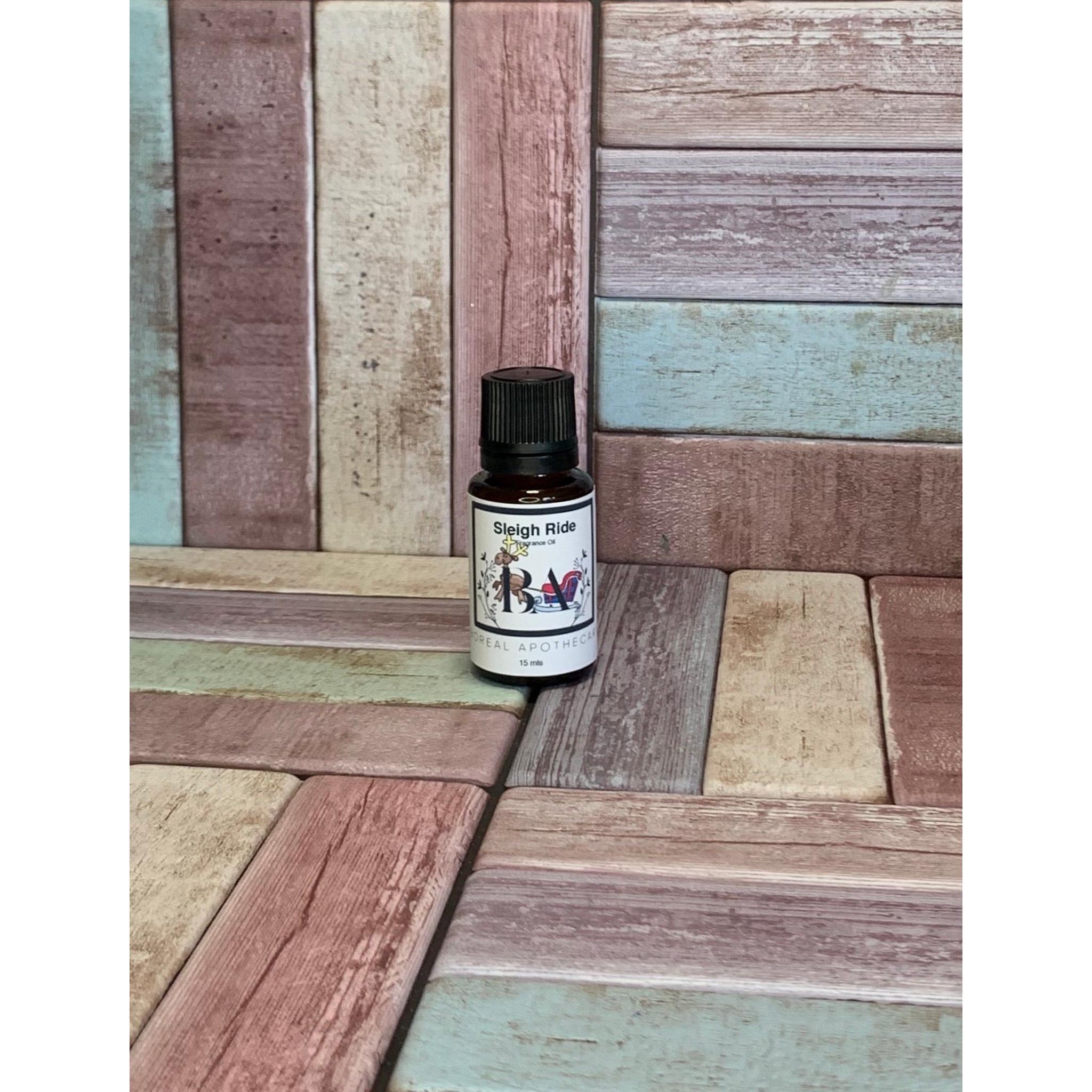 Bottle of Sleigh Ride Fragrance Oil  on a wooden surface