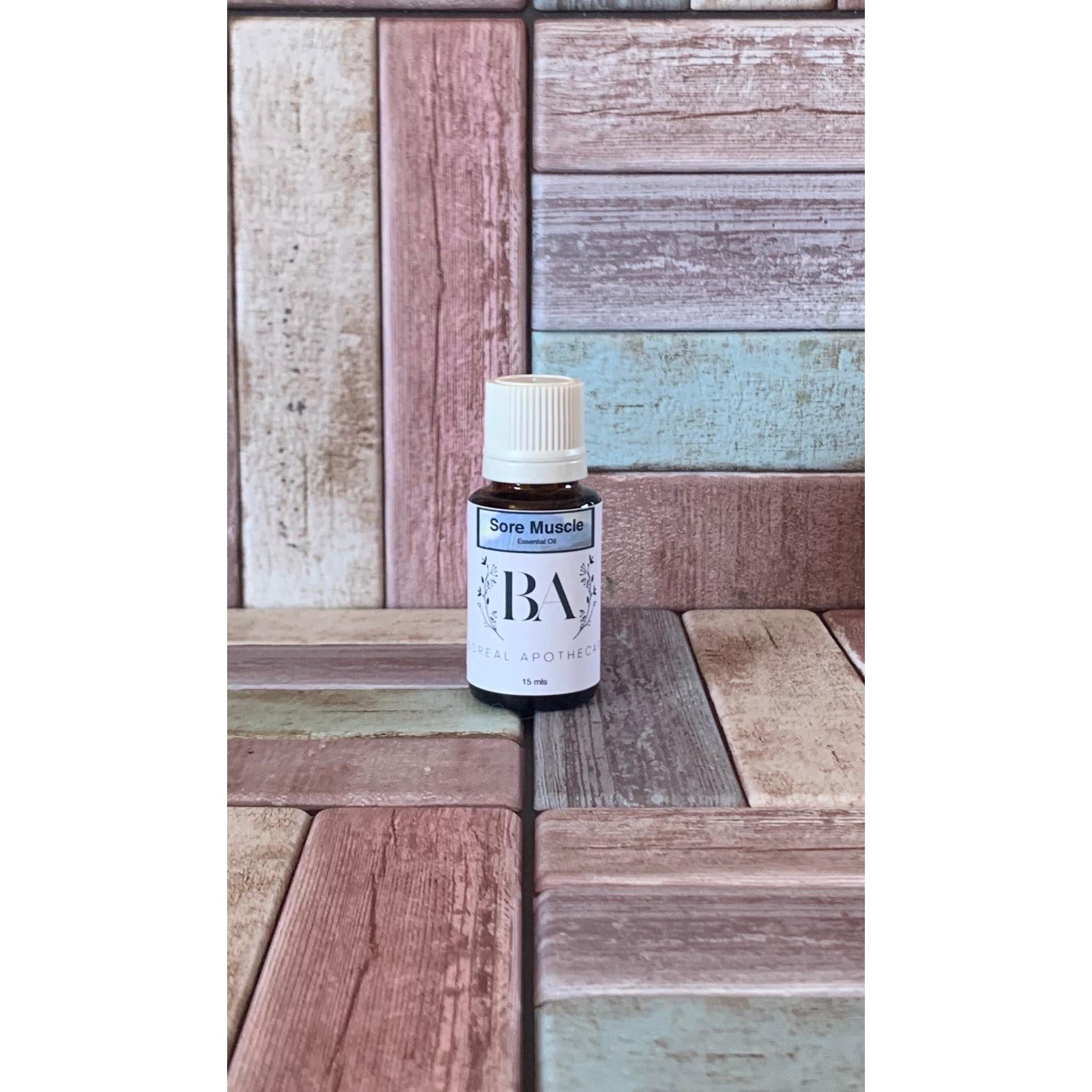 Bottle labeled 'Sore Muscle' on a wooden surface with a multicolored background