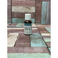 Bottle of Wintergreen essential oil on a multi-coloured tiled surface