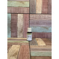 Bottle of patchouli essential oil  on a wooden surface with a multi-coloured pattern