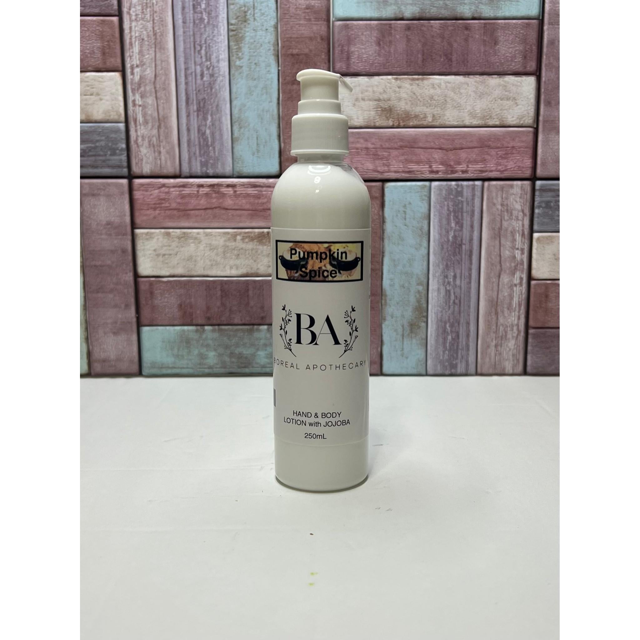 White pumpkin spice lotion with 'BA' branding against a wooden panel background