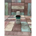 Bottle of Spearmint essential oil from Boreal Apothecary on a wooden surface.