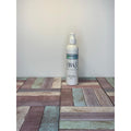 White bottle with a label on a wooden surface